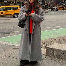 @tia_dewitt nyc winter outfit, grey long coat with a red scarf and chanel 25 bag