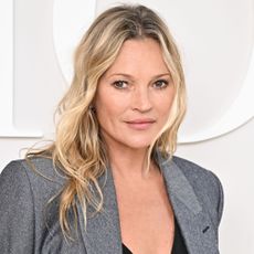 Kate Moss wears a gray blazer