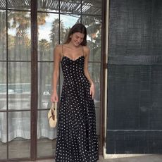 sara walker wearing a polka dot maxi dress
