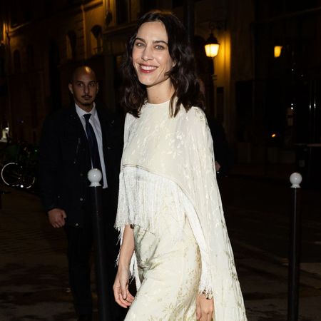 Alexa Chung wears a tassel dress with black curved heel shoes.