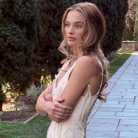Margot Robbie promotes Wuthering Heights wearing a feathered minidress
