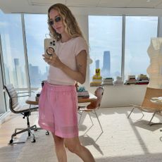 a woman wears pink nylon shorts by J.Crew