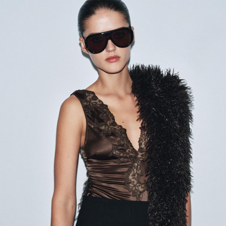 a Zara model wearing aviator sunglasses, a lace-trimmed tank, and faux-fur stole