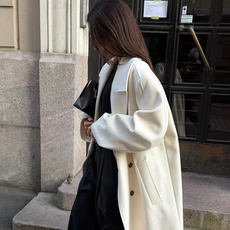 Woman wearing white coat.